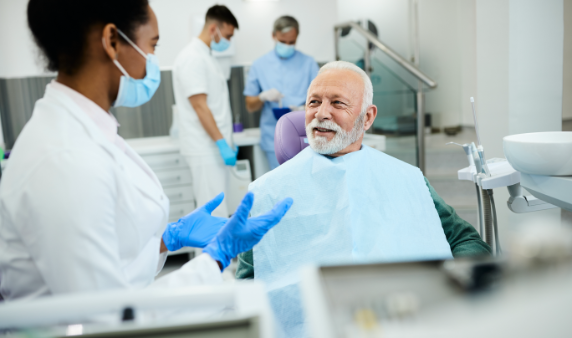 A dental professional prepares to assist a patient.