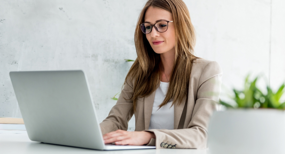 brown-hair with glasses, business woman looking at computer screen